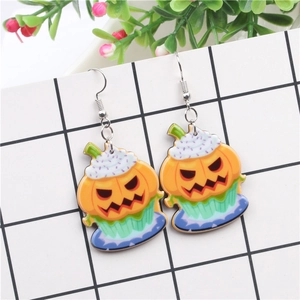 Detail of Halloween pumpkin cupcake earrings with white cream and purple dots hook design