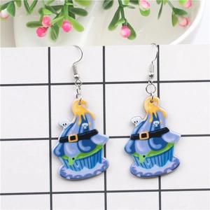 Detail of Halloween cupcake earrings with skull accents and yellow melting drips