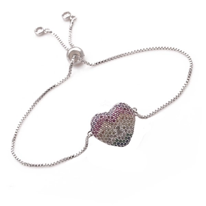 Detail of adjustable silver bracelet with a heart pendant and rainbow zircon stones