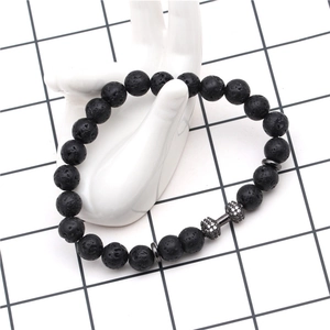 Close-up of 8mm volcanic stone beads bracelet with micro-pave zircon dumbbell charm