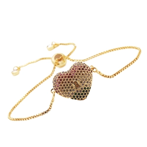 Detail of adjustable box chain bracelet with colorful pavé zircon heart and keyhole charm
