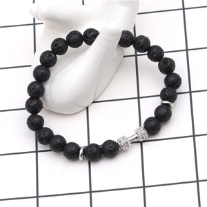 Detail of 8mm black lava stone beads and zircon paved dumbbell charm on beaded bracelet
