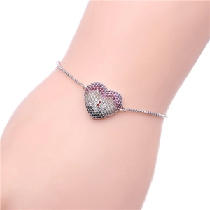 Detail of adjustable silver bracelet with a heart pendant featuring rainbow pavé zircon
