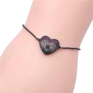 Detail of adjustable black box chain bracelet with rainbow zircon heart charm on wrist