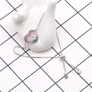 Detail showing rainbow zircon heart pendant on adjustable silver bolo bracelet