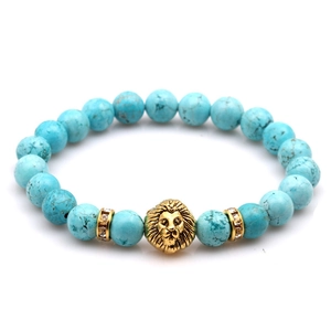 Turquoise bead bracelet with a golden lion head and sparkling spacer accents
