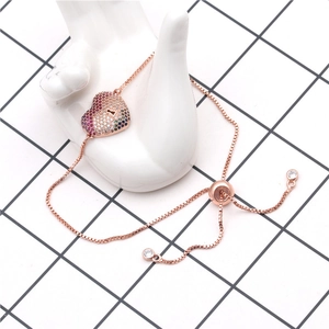 Detail of rose gold heart lock bracelet with colorful zircon pavé and adjustable box chain