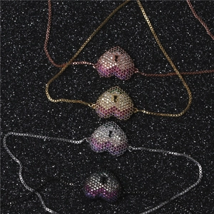 Detail of heart lock bracelets with gradient pavé zircons and adjustable slider chain