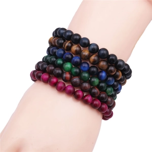 Detailed view of layered 8mm tiger eye stone beaded bracelets in multi-color finishes
