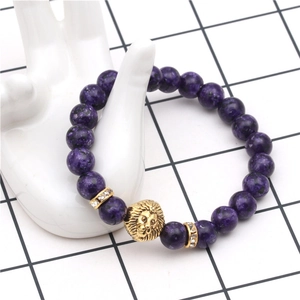 Macro shot of purple stone bead bracelet featuring golden lion head and zircon spacers