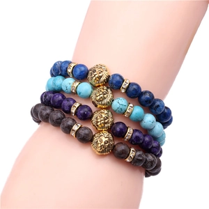Detailed close-up of four colorful beaded bracelets featuring golden lion head charms