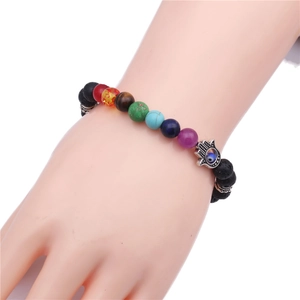 Hamsa Hand Lava Rock Bracelet with 8mm Chakra Beads and Evil Eye Charm on Wrist
