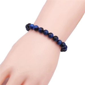 Detailed shot of dark blue tiger eye beads and black polished round beads bracelet