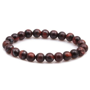 Detailed macro view of 8mm polished natural red tiger eye stone beaded bracelet