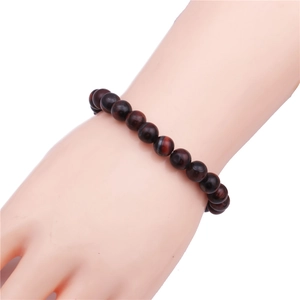 Detail shot of 8mm red-brown tiger eye stone beads bracelet with high polished silk luster