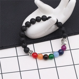 Detail of 8mm lava rock chakra bracelet with colorful beads on a white hand model