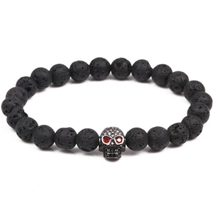 Lava stone bead bracelet with a crystal-studded skull charm featuring red stone eyes