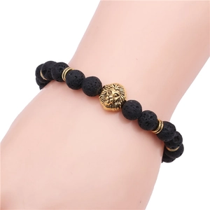 Close-up of men's lava rock beaded bracelet with golden lion head on model wrist