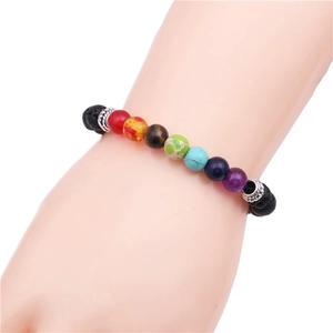 Detail of 8mm Seven Chakra lava stone bracelet with colorful beads on a wrist
