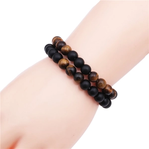Matte black stone and tiger eye bead bracelet set for men and women worn on wrist