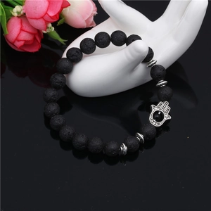 Black lava rock 8mm beaded bracelet with silver Hamsa Hand charm on hand display