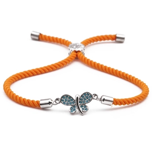 Adjustable orange braided rope bracelet with silver butterfly charm and blue zircons