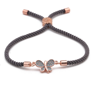 Adjustable butterfly bracelet featuring turquoise stones on a grey braided rope cord