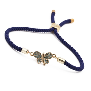 Adjustable blue braided butterfly bracelet with gold metal and zircon inlay on white base