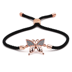 Adjustable black rope bracelet with rose gold butterfly charm and blue crystal stones