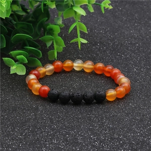 Detalle de la pulsera elástica de cuentas de ágata naranja y piedra de lava de 8mm