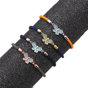 Macro shot of colorful woven bracelets with micro-pave zirconia butterfly charms