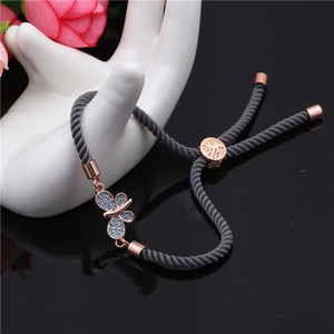 Adjustable gray woven evil eye butterfly bracelet with rose gold sliding clasp and blue stones