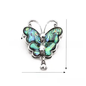 Detail of butterfly brooch featuring natural abalone shell inlay and crystal accents