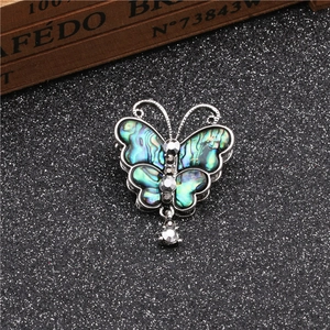 Elegant silver butterfly brooch with abalone shell wings and sparkling crystal accents