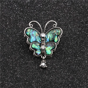 Elegant butterfly brooch with iridescent abalone shell wings and white rhinestones
