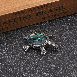 Vintage silver turtle brooch with colorful abalone shell inlay on textured metal