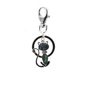 Silver cat keychain pendant inlaid with iridescent abalone shell on white background
