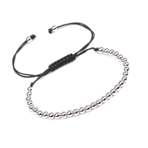 Detail of beaded bracelet showing silver metal beads on adjustable black cord string