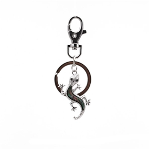 Detail of silver gecko keychain with iridescent abalone shell inlay and lobster clasp