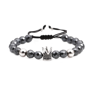 Faceted hematite beaded bracelet featuring a silver crown charm with black cubic zirconia