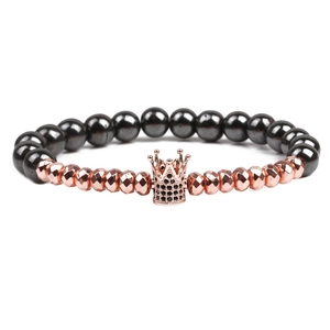 Men's crown hematite beaded bracelet with rose gold zircon accents on white background