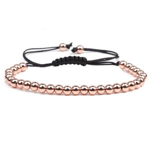 Adjustable rose gold beaded bracelet with black woven cord and polished metal spheres