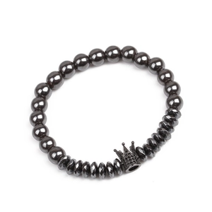 Detail of beaded hematite bracelet with crown charm and faceted metallic beads