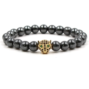 Handmade beaded bracelet with polished black hematite stones and golden leopard head charm