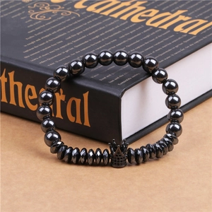 Detailed macro view of black hematite beads with a micro-paved zircon crown charm for men