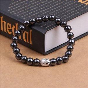 Detailed view of silver Buddha head bead on black hematite stone beaded bracelet