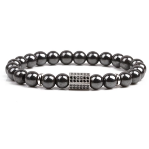 Mens magnetic hematite bead bracelet with a black zircon rectangle charm on white background