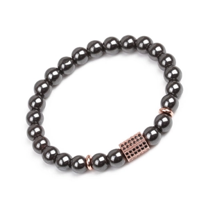 Close-up of magnetic hematite beads with rose gold accents and pavé black zircon plaque
