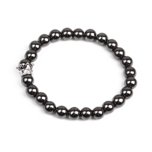 Detailed view of magnetic hematite beads with a silver zircon crown charm on bracelet
