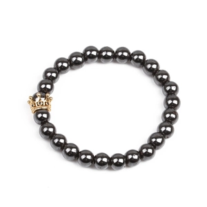 Detail shot of magnetic hematite beads and gold-plated crown with zircon micro-inlay